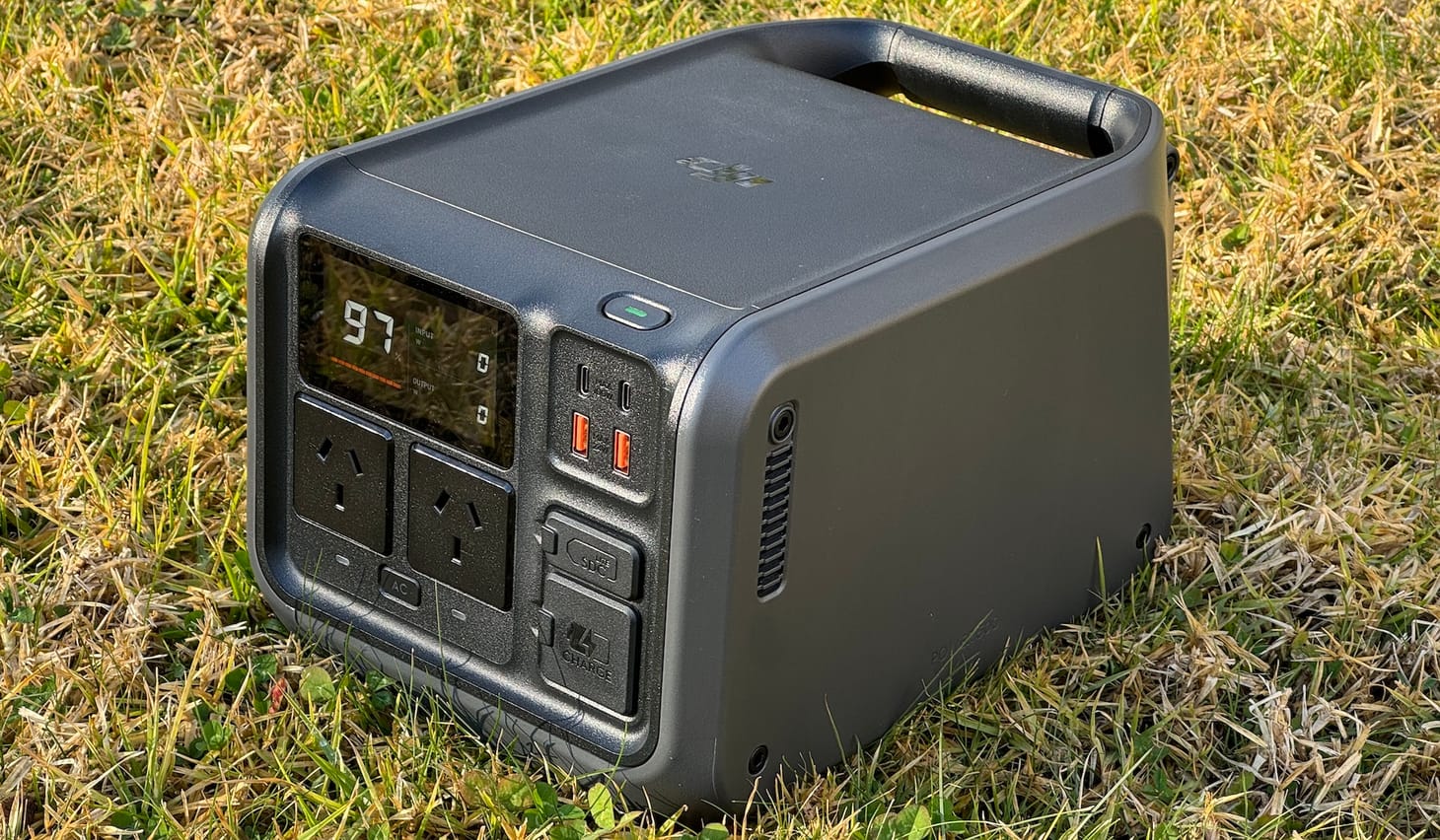 The DJI Power 500 power station sitting on grass.